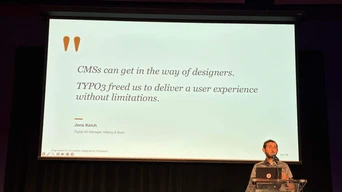 A speaker presents at a conference, discussing how TYPO3 enhances user experience, with a quote displayed behind them.