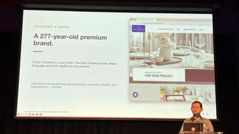 A speaker presents information about a 277-year-old premium brand, showcasing a website with design elements and project details.