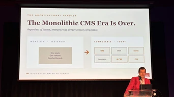 A speaker presents at a conference, discussing the transition from monolithic CMS to composable systems, with a comparison chart displayed behind.