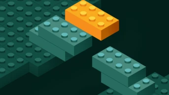 An orange LEGO brick is positioned above two green LEGO bricks, creating a bridge-like structure against a dark background.