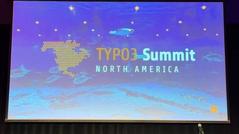 Presentation screen displaying "TYPO3 Summit North America" with a blue aquatic background and a podium in front.