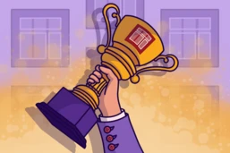 A hand holds up a golden trophy with a logo, set against a blurred background of a building.