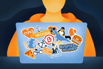 A laptop covered in various colorful stickers, including themes of hacking, programming, and open source, alongside illustrations of a globe, pizza, and a penguin. A person in an orange hoodie is seated in front of the laptop.
