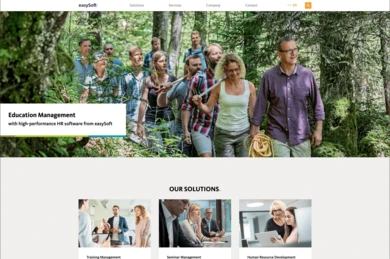 A group of diverse individuals is walking together through a forested area, engaged in conversation. The scene conveys a sense of teamwork and collaboration. A banner at the top highlights "Education Management" and HR software from easySoft.