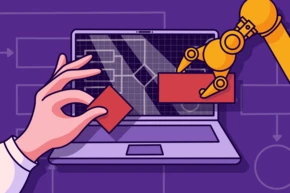 A robotic arm is positioned near a laptop screen displaying a grid and technical diagrams, while a human hand holds a red block, suggesting interaction between technology and manual input.