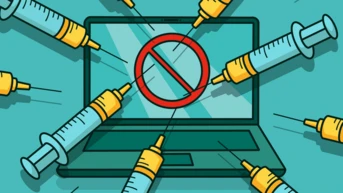A laptop is surrounded by multiple syringes, with a red prohibition symbol displayed on the screen, indicating a message against vaccination or medical intervention.